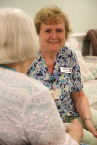 Certified Nursing Assistant talking with a resident